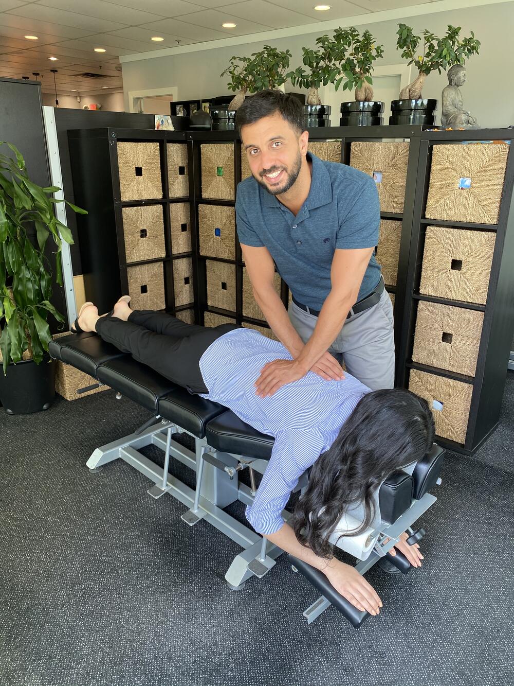 Dr. Ali Amiri aligning a patien'ts spine in the coquitlam chiropractic clinic.